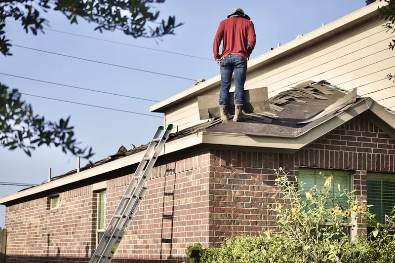 Professional roofer working on a residential roof in Mahwah